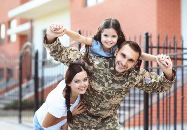Photo of a veteran with his two daughters